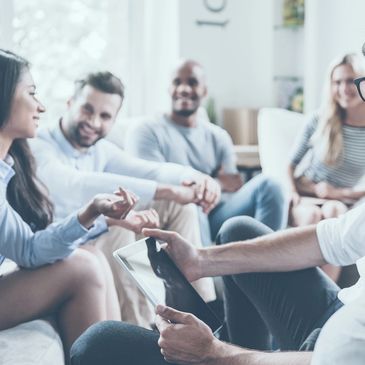 Group of people smiling or watching each other.