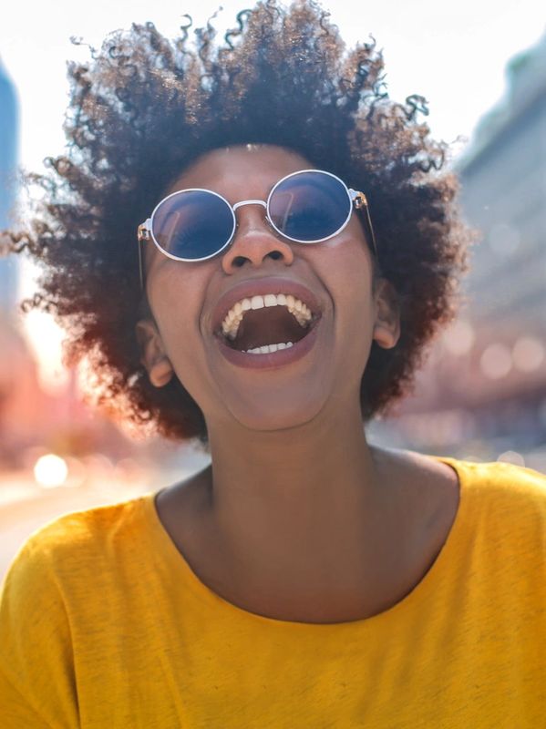 person smiling joyfully being transformed wearing a yellow jumper to show my complete style package