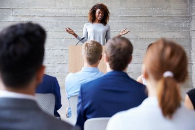 Keynote speaker, presenting content to an audience.