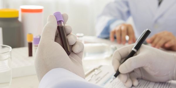 lab workers holding vials