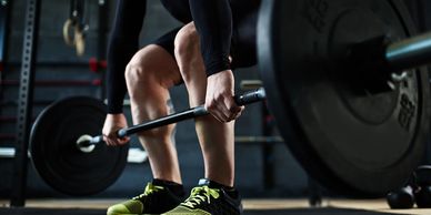 A person lifting a barbell. 