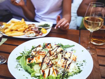 Outdoor dining table with fresh fish and wine