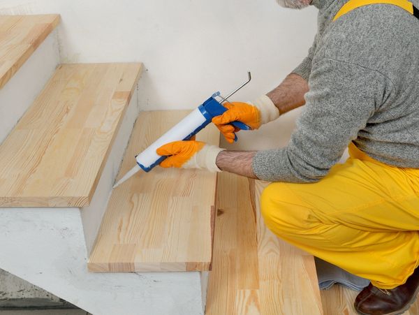 Carpenter installing wooden stairs