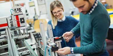 Two people working on a machine