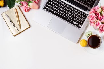 workspace with an open laptop notebook and pens