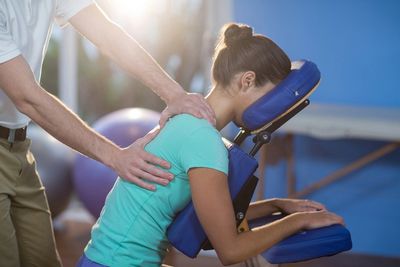 Worker receiving on-site seated acupressure massage