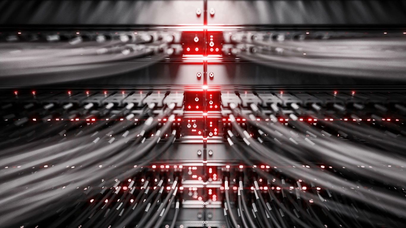 Network cables connected to a server with red indicator lights.