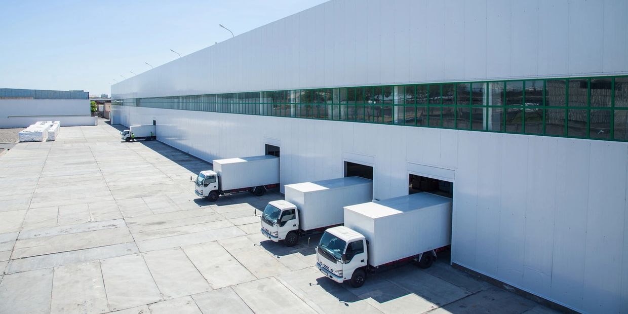 Multiple trucks making delivery drop-off