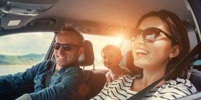 Family smiling in car
