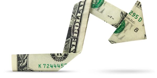 A folded dollar bill shaped like an upward arrow.