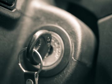 Close-up of a car key in the ignition switch.