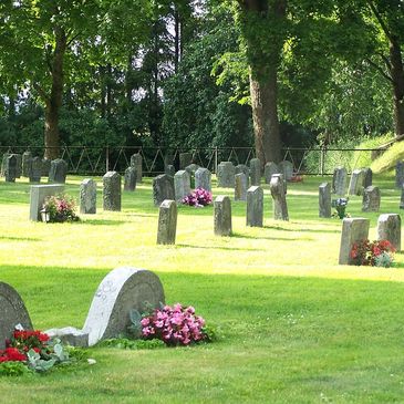 cleaned headstones with planted flowers