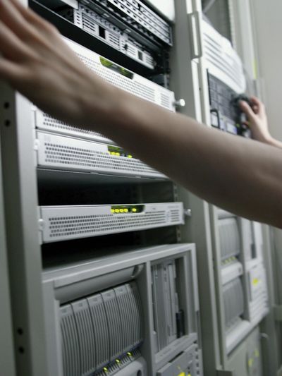 Technician working on server racks in a data center.