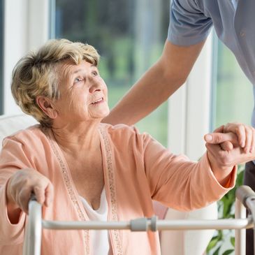 A caregiver offering support to a senior at Life of Riley Senior Care