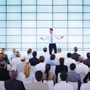 Large conference with man on stage and engaged audience