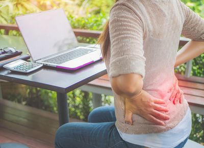 woman holding her hips due to pain