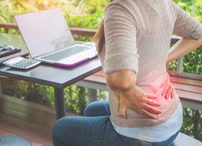 Women having lower back pain while sitting