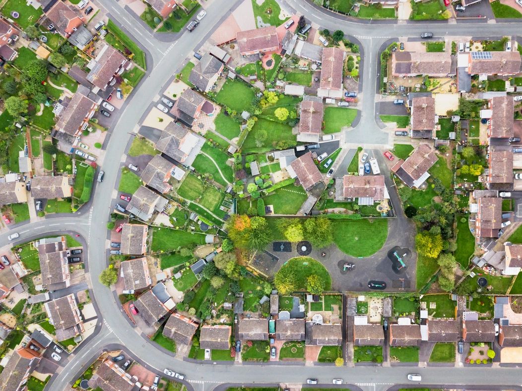 Aerial view of a suburban neighborhood with houses and a park.