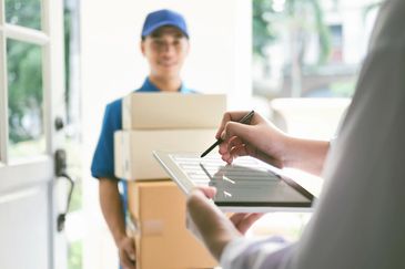 Courier making a same-day delivery and executing reverse logistics