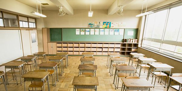 Photo of a classroom with desks in rows. 