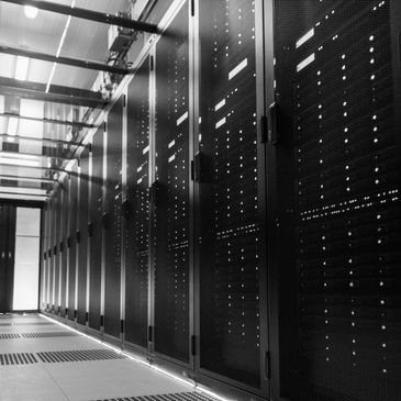 A black and white photo of a server room with multiple server racks.