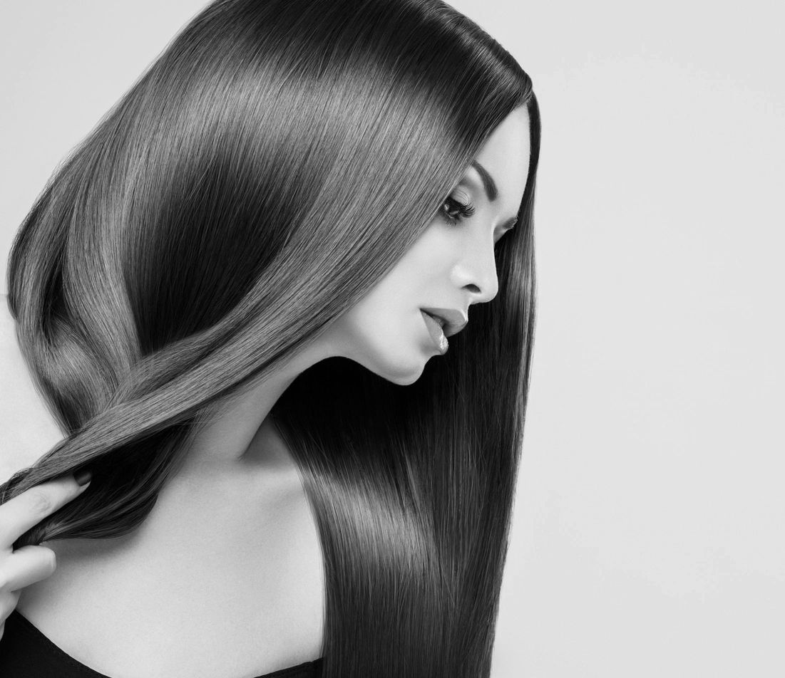 Woman with long, smooth, shiny hair in a black and white portrait.