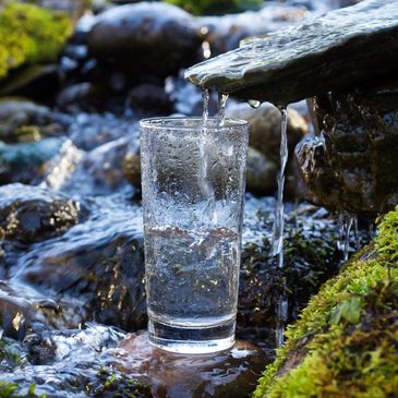 Glass of water filled from a natural spring