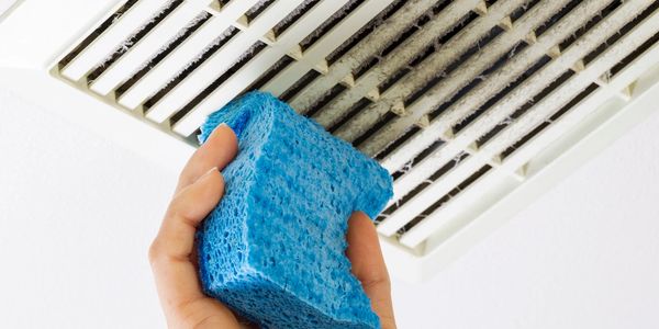 Sponge cleaning air vents in a deep clean service. 