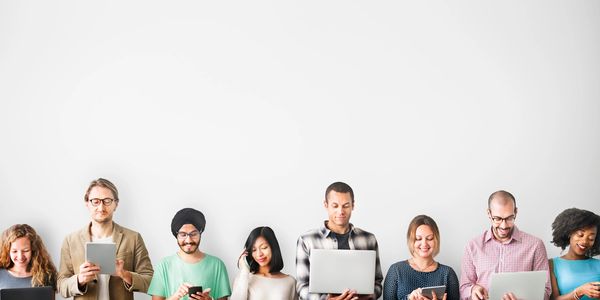 Group of people using laptops, smart phones, and tablets to stay connected