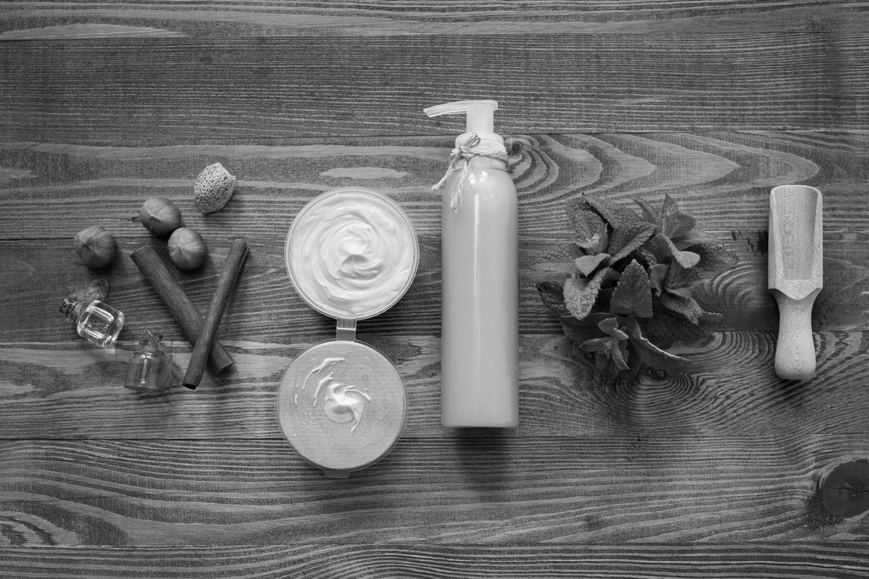 Skincare and wellness products arranged on a wooden surface.