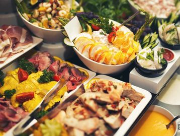 A colorful spread of various dishes in bowls and trays.