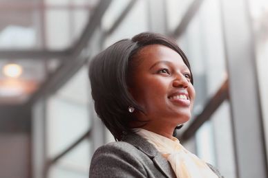 Confident woman smiling, looking to the side.