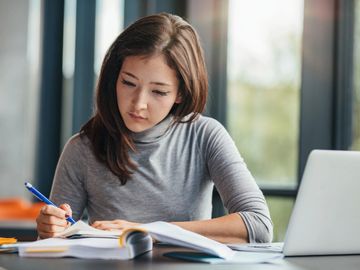 a person working hard on a textbook 