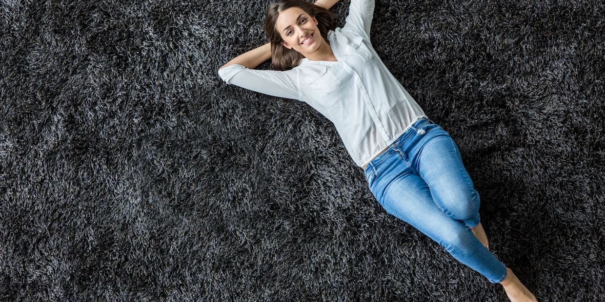 Woman laying on plush carpet clean by Panther Plush Carpet Cleaning in Chicago.