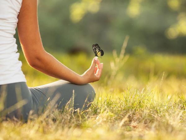 Woman sitting with butterfly