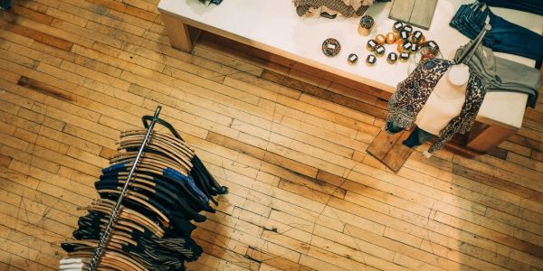 Overhead view of a clothing display and rack on wooden floor.