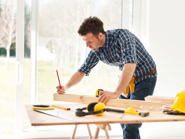 General contractor reviewing construction plans at a jobsite with tools