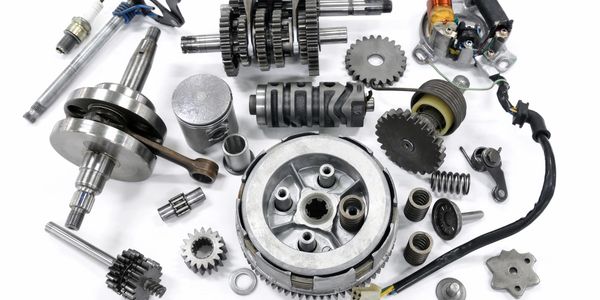 Collection of metal mechanical parts on a white background.