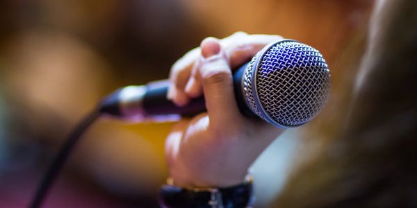 Person holding a microphone.