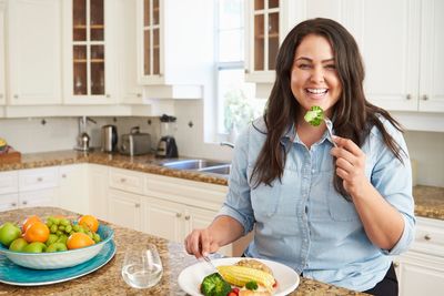 Happy Woman eating healthy food