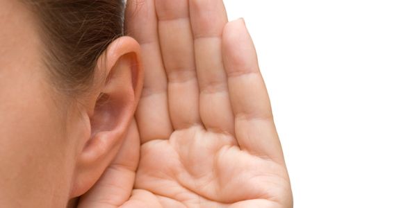 women cupping hand behind her ear