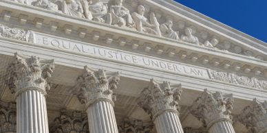 Front facade of a courthouse with the phrase "Equal Justice Under Law".