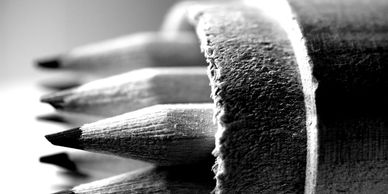 Close-up black and white photo of sharpened pencils.