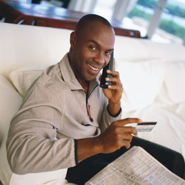 This man is paying a bill or debt via telephone. He has a strategy to mange debt and save money.