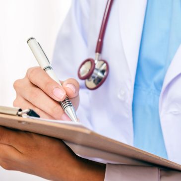 a doctor writing down notes on a notepad