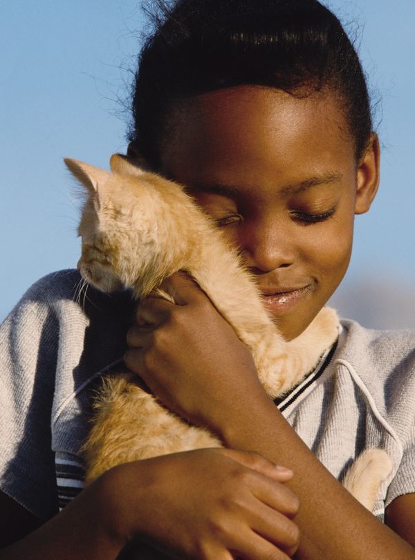 A child holding her cat