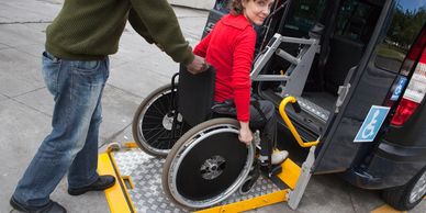 woman using a wheelchair accessible van with a wheelchair lift for entry.