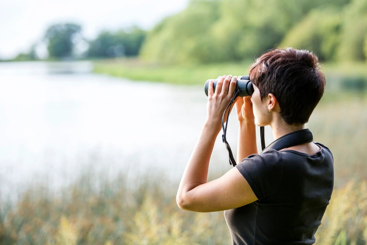 Person looking through binoculars 