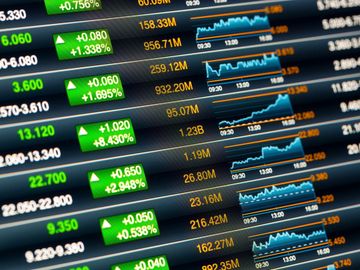 Stock market data with rising prices and trend graphs.