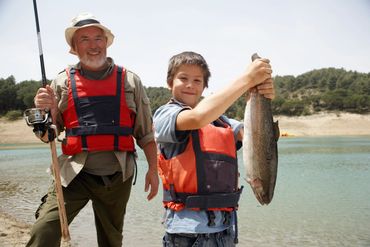 A man and a boy with the fish they caught